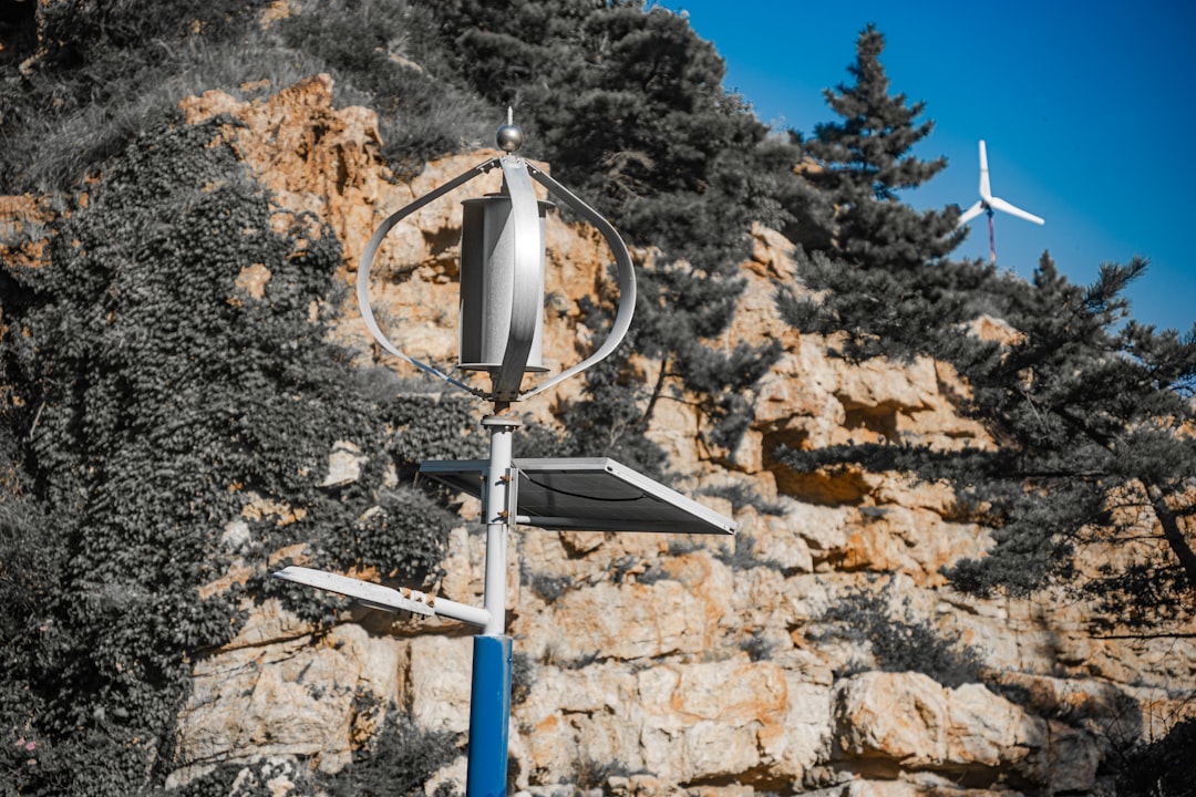 a-street-sign-with-a-wind-turbine-in-the-background-th62xqme1oy